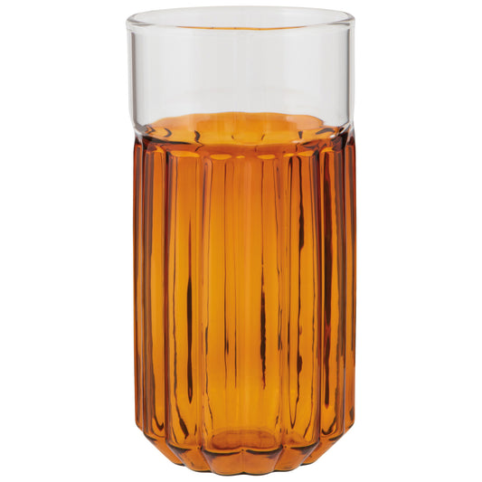 Amber-colored glass with ribbed design filled with a clear liquid on a white background