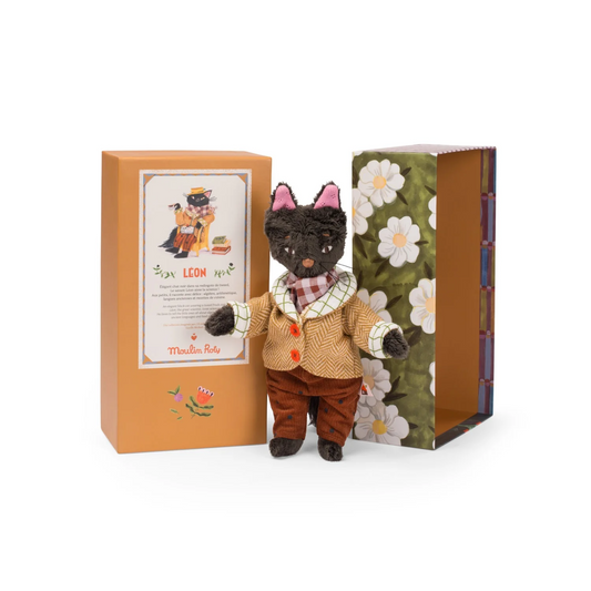 A stuffed toy doll named Leon the Cat, wearing a tweed frock coat, standing next to its packaging box with floral design.